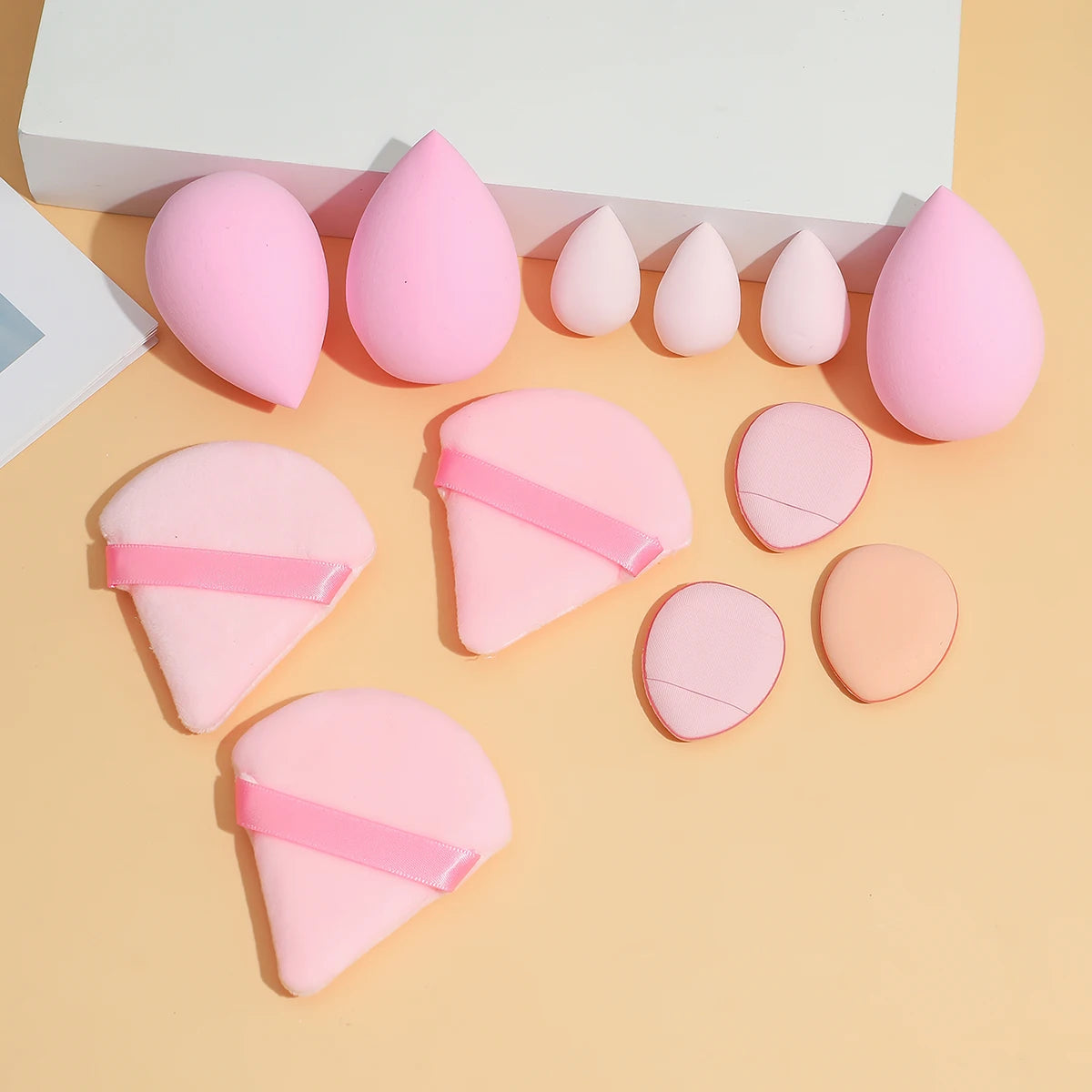 16-piece makeup set, a makeup kit, includes a three-piece hairband set, makeup sponges, and cleansing tools.